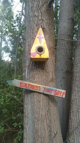 a birdhouse on a tree with a sign on it at Klipfontein Rustic Farm & Camping in Tulbagh