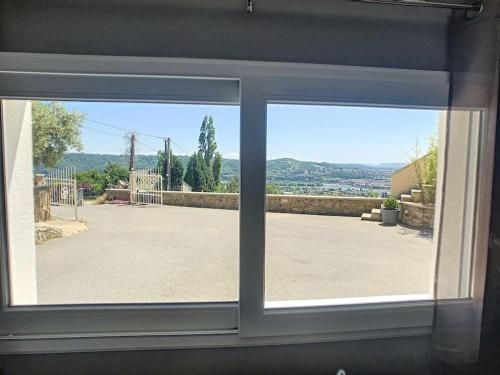 a window with a view of a patio at Condrieu, le Châtillon au cœur du vignoble belle vue sur vallée du Rhône in Condrieu