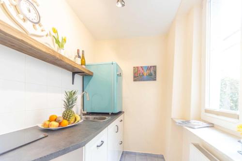 a kitchen with a bowl of fruit on a counter at Ferienwohnungen in der Altstadt Stralsund in Stralsund
