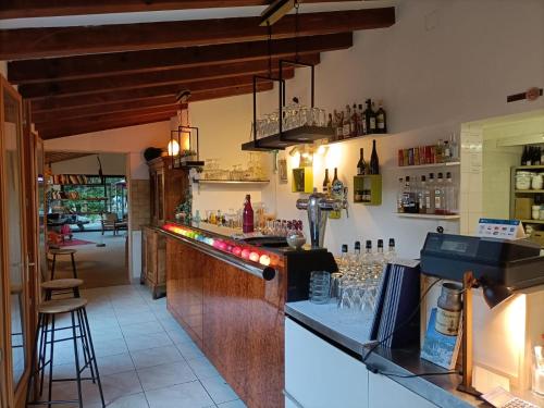 a bar with a counter with glasses on it at Camping Milella in Propriano
