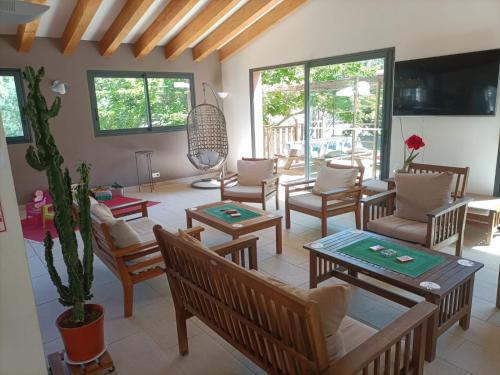 a living room with a lot of chairs and tables at Camping Milella in Propriano