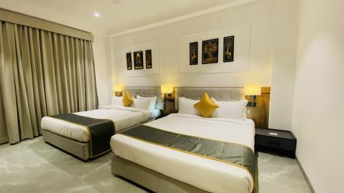 a hotel room with two beds and a window at The Shankara View in Godarpura