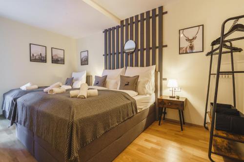 a bedroom with a large bed and a ladder at ALPSTAY Platzhirsch - Ski-In & Ski-Out in Bad Kleinkirchheim