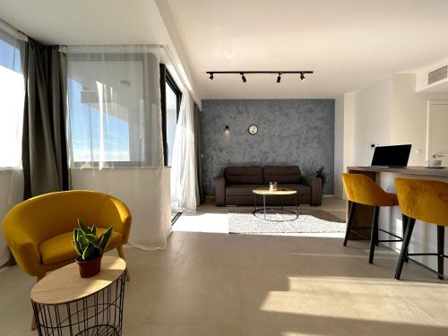 a living room with yellow chairs and a couch at Sandi Hvar Apartments in Hvar