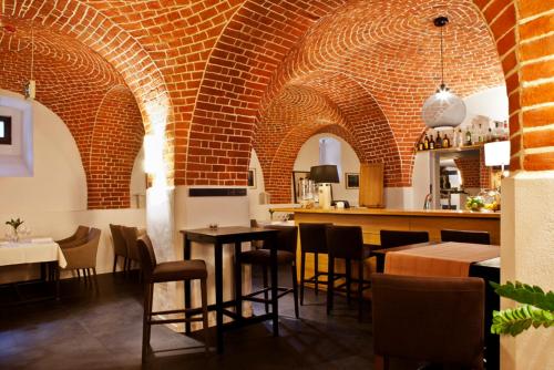 a restaurant with brick walls and tables and chairs at Great Polonia The Granary La Suite Hotel in Wrocław