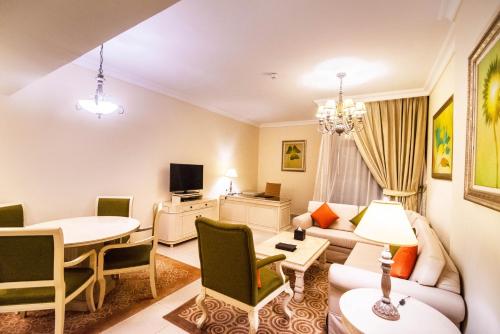 a living room with a couch and a table at Mercure Dubai Barsha Heights Hotel Suites And Apartments in Dubai