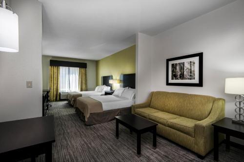 a hotel room with a bed and a couch at Holiday Inn Express Conway by IHG in Conway
