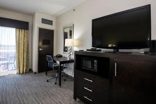 a hotel room with a flat screen tv and a desk at Holiday Inn Express Conway by IHG in Conway
