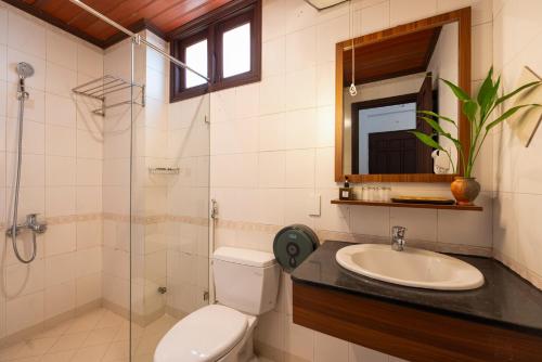 a bathroom with a toilet and a sink and a shower at Hoianese Heritage Hotel - Truly Hoi An in Hoi An