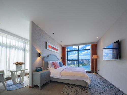 Vanbrugh Bay Hotel - Zhangjiajie Tianmen Mountainにあるベッド