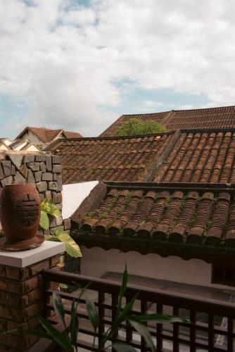 a roof of a building with a vase on a ledge at Hoianese Heritage Hotel - Truly Hoi An in Hoi An