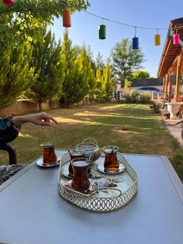 a tray of tea cups and saucers on a table at Çamlarkent Villaları 