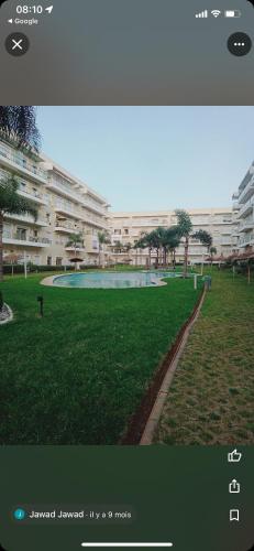 a view of a park with a large building at Residence kettani Bouznika in Bouznika