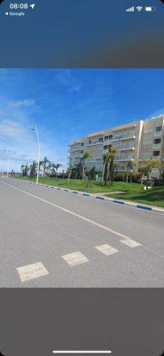 an empty road with a building in the background at Residence kettani Bouznika in Bouznika