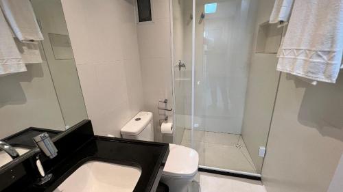 a bathroom with a shower and a toilet and a sink at Studios Premium RN in Maceió