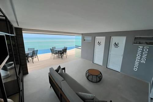 a living room with a view of the ocean at Studios Premium RN in Maceió