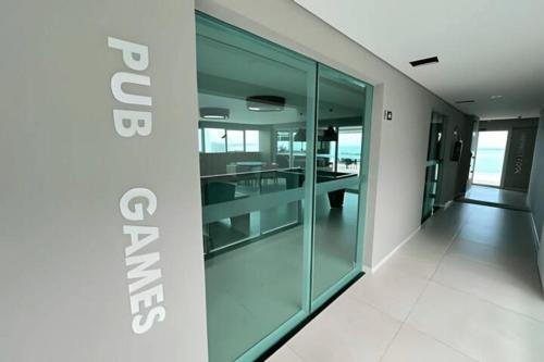 an empty hallway with glass doors in a building at Studios Premium RN in Maceió