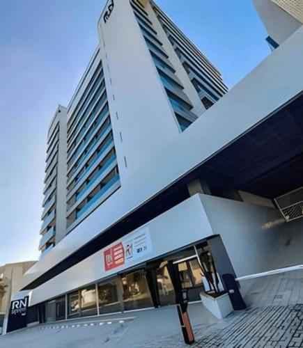 a building with two tall buildings in the background at Studios Premium RN in Maceió