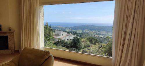 a large window in a living room with a view at Villa Mas Nou in Castillo de Aro