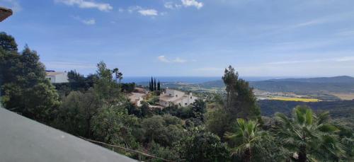 a view of a house on a hill with trees at Villa Mas Nou in Castillo de Aro