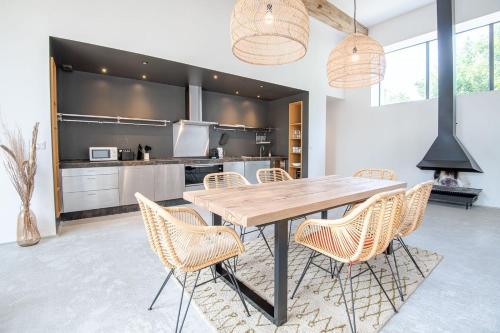 a kitchen with a wooden table and chairs at Domaine La Restrie - La Grande Salle des Médicis in Pocé-sur-Cisse