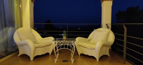 two chairs and a table on a balcony at Villa Mas Nou in Castillo de Aro
