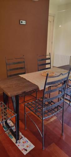 a dining room table with chairs and a wooden table and chairs at Villa Mas Nou in Castillo de Aro