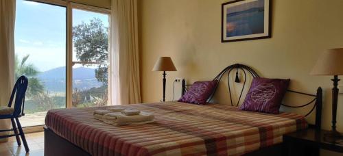 a bedroom with a bed with a large window at Villa Mas Nou in Castillo de Aro