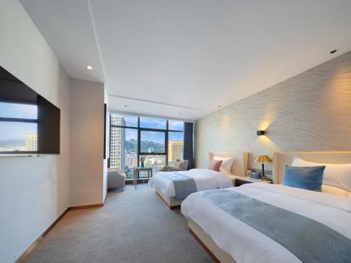 Vanbrugh Bay Hotel - Zhangjiajie Tianmen Mountainにあるベッド