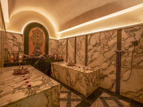 a large bathroom with a tub and a sink at Riad Almisk in Marrakech