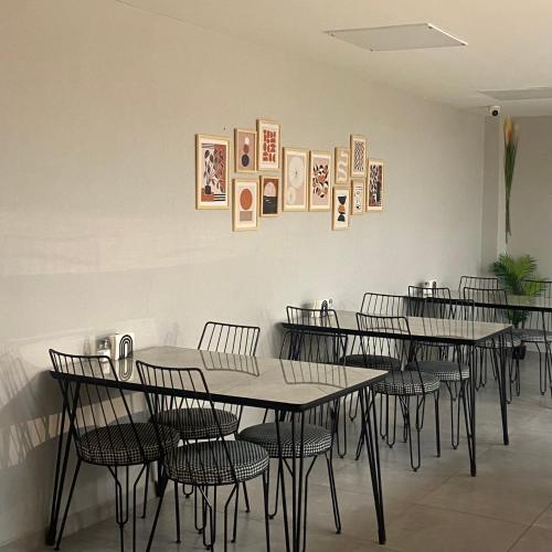 a dining room with tables and chairs and pictures on the wall at BRANDROOM HOTEL in Istanbul