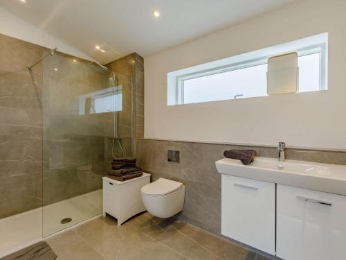 a bathroom with a toilet and a sink and a shower at 1 Bed in Stokesley 86814 in Great Broughton