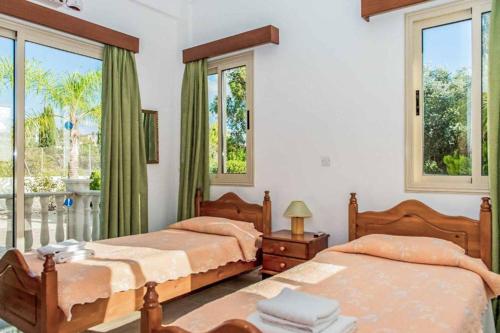 1 Schlafzimmer mit 2 Betten und einem Fenster in der Unterkunft Villa Theo in Peyia