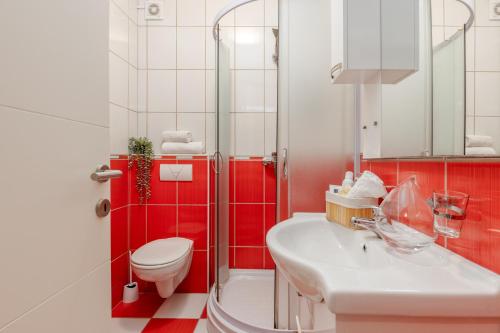 a bathroom with a toilet and a sink and a shower at Elegance Duplexes by Monte Aria in Herceg-Novi