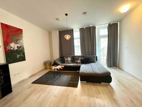 a living room with a couch and a table at Amazing large 2,5rooms with terrace and parking! in Bratislava