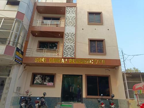 a building with a sign on the front of it at Shri Girraj Residency in Mathura