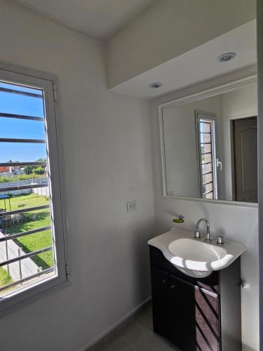 a bathroom with a sink and a large window at Casa Muka in Tandil