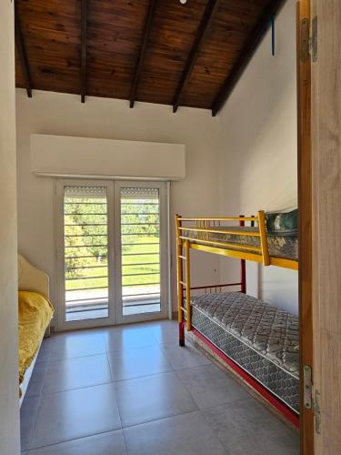 a bedroom with two bunk beds and a doorway at Casa Muka in Tandil