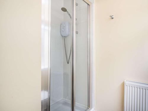 a shower with a glass door in a bathroom at 3 Bed in Ullswater 85896 in Penruddock