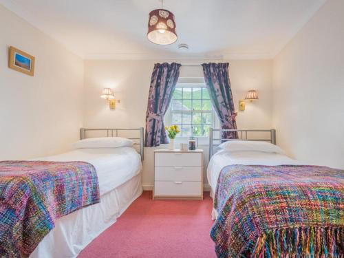 a bedroom with two beds and a window at 2 Bed in Wasdale SZ413 in Nether Wasdale