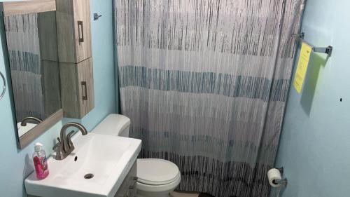 a bathroom with a sink and a shower curtain at Near Casa Bacardi, 5 beds, Sleeps 10, Beach Town, Unit 1 in Catano