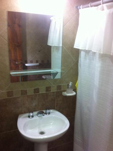 a bathroom with a sink and a mirror at La Aldea in San Rafael