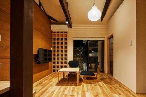 a dining room with a table and two chairs at Mibu Hanabusa House in Kyoto