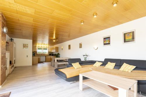 a living room with two beds and a couch at 65 qm Ferienwohnung im Sauerland in Finnentrop
