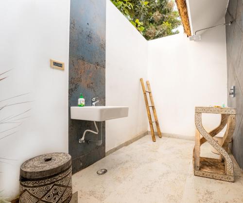 a bathroom with a sink and a mirror at CSR Landmark Resorts in Coimbatore