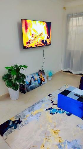 a living room with a painting on the wall at Newly Furnished 1-bedroom in Nairobi