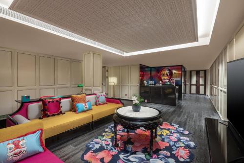 a living room with a couch and a table at Hotel Indigo Guangzhou Haixinsha by IHG - Free Shuttle Bus to Canton Fair Complex during Canton Fair period in Guangzhou