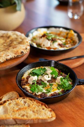 a table with three plates of food on a table at The Tokyo Aparthotel by Totalstay in Cape Town