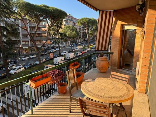 a balcony with a table and a view of a city at LA TORTORELLA HOME DI ROMA TALENTI in Rome