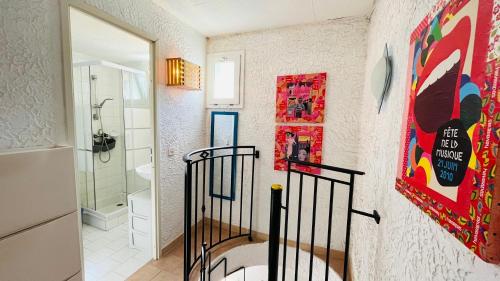 a bathroom with a walk in shower and a sink at Appartement Cocody 3 LUMIO in Lumio